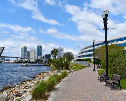 Exterior photo of Jacksonville office along the river. City skyline is in the back ground.